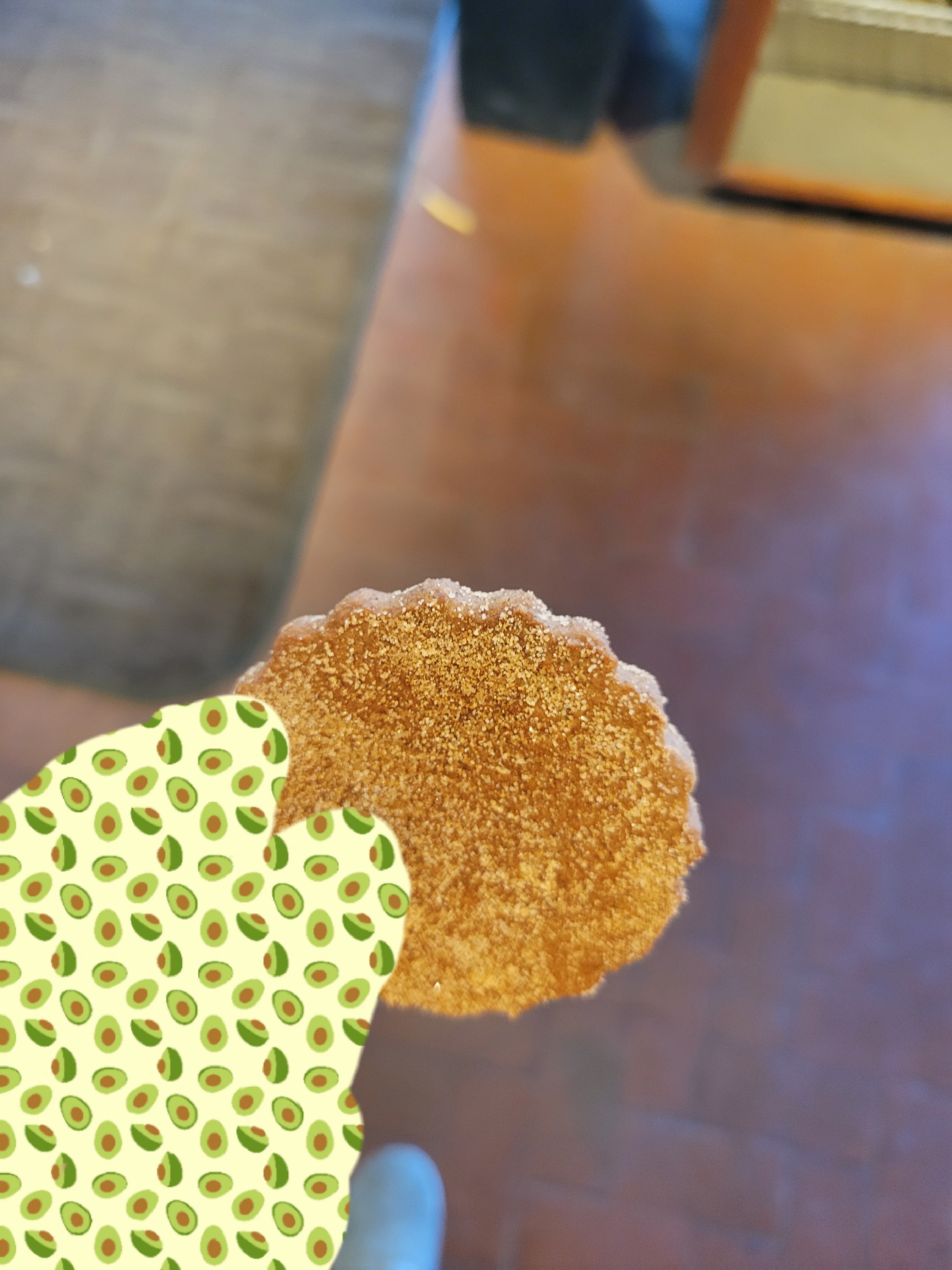 Hand holds a biscochito.